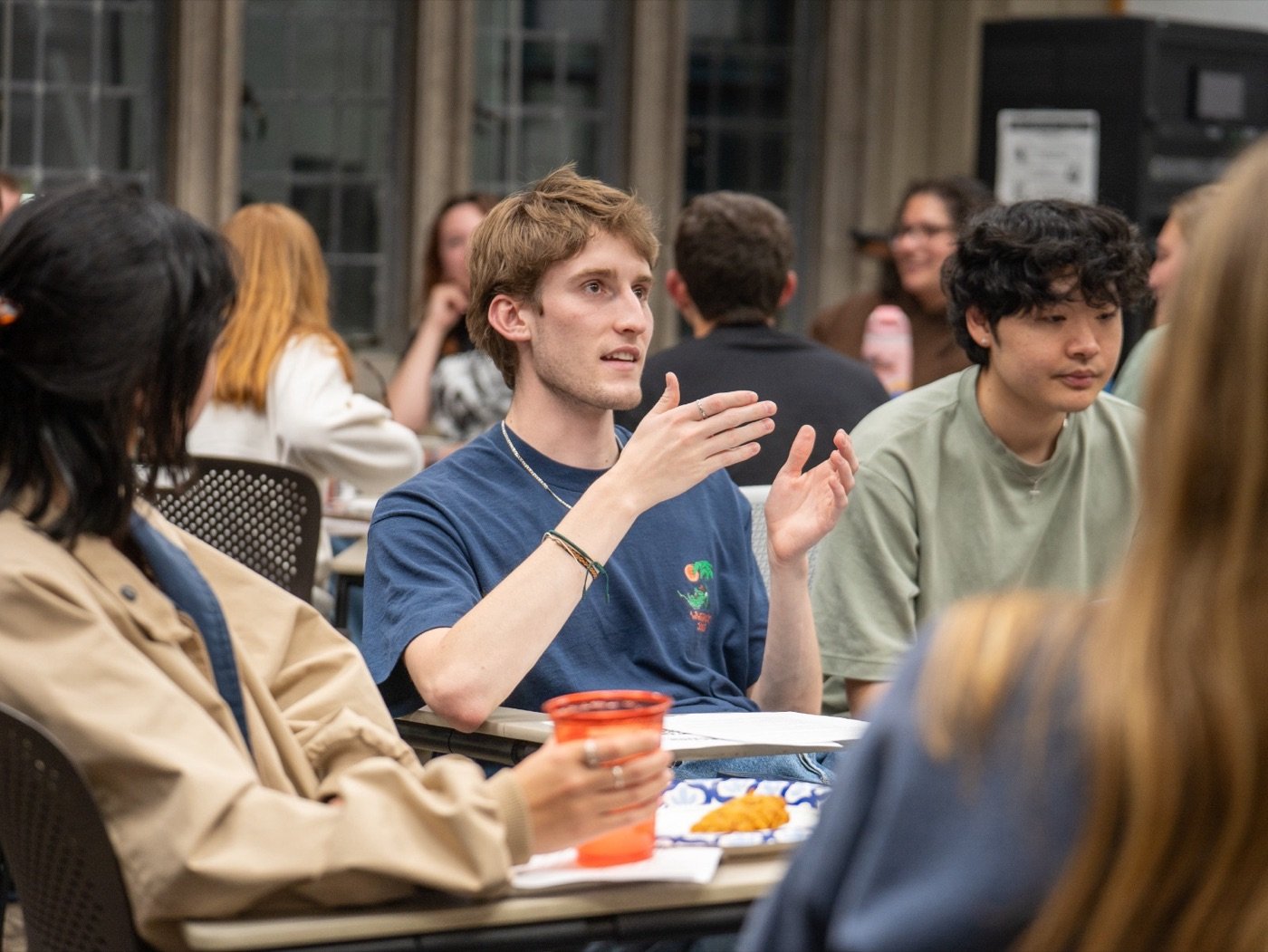A student gesturing as he talks